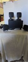Subwoofer with four satellite speakers displayed