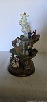 Full frontal view of the multi-scene Life of Christ figurine on base