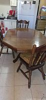 Pedestal dining table with chairs around