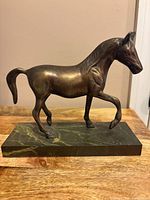 Front view of bronze horse sculpture on marble base