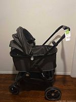 Side view of gray Kemyone pet stroller showing canopy, frame and wheels
