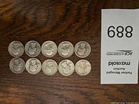 Front and back view of all ten Washington quarters laid out in two rows