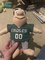 Front view of Fred Flintstone plush showing Eagles jersey and number 00