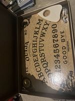 Game board inside box with planchette
