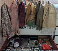 Scarves hanging and pouches in drawer