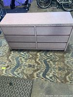 Front view showing six drawers and pink finish