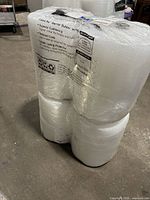 Bundle of four Sealed Air bubble wrap rolls shrink-wrapped together