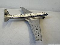 Left-front view showing overall airplane, paint loss, wheels