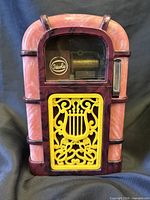 Front view showing marbled plastic cabinet, yellow lyre grille and Ideola logo in window