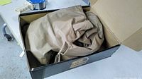 Waders folded inside Hodgman-branded cardboard box