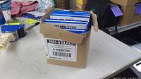 Open brown carton showing six sealed KO-REC-TYPE ribbon boxes and exterior label stating 3401-0 Black, 6 ribbons