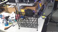 Full view of metal magazine rack on table