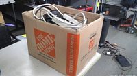 Box filled with assorted power strips and surge protectors