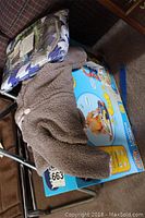 Photo showing Carters fuzzy bear onesie on top of boxed Vtech Sit to Stand Learning Walker and a packaged Bonafide Baby infant car seat cover.