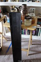 Candles including Yankee, Woodwick, and Country Classic brands displayed on a small wooden folding table.