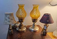 Group of four lamps on tabletop