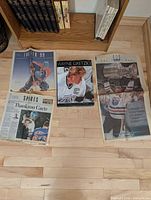 Four Wayne Gretzky related printed pieces displayed on floor