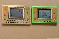 Front view of both handheld LCD games showing screens, controls, model names