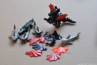 Group shot showing dragon, sharks, wings, crocodile and small figures