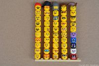 Full set of 50 Lego heads aligned on baseplate