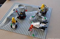Overview of baseplate with assembled vehicles and minifigures