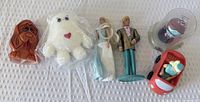 Group shot of all six toys lined horizontally on white surface
