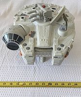 Top view of closed Millennium Falcon with tape measure showing width
