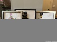 All three framed prints partially visible