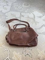 Front view showing leather, handles, strap attached