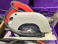 Milwaukee grey/red 7-1/4 in. circular saw showing cord and blade