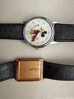 Front view of both watches showing dials, cases and straps