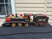 Side view of locomotive and tender, number 535-69 visible
