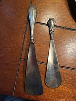 Pair of shoehorns showing full length and size difference