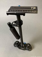 Full view of stabilizer showing plate, shaft, handle, counterweights