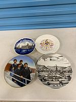 Four assorted decorative plates laid out