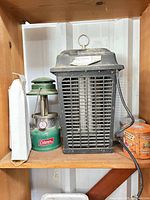 Coleman lantern, Lil' Bug'r bug zapper and boxed wipes on shelf