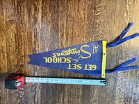 Full pennant beside tape measure showing length