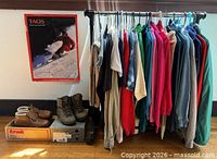 Full lot showing clothing rack, boots, signed poster