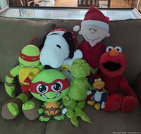 Group shot of all seven licensed character plush toys on couch