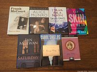 All seven hardcover books laid out showing covers