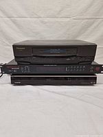 Front view of stacked Panasonic VCR, Rockville amplifier, Toshiba DVD recorder