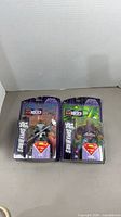Both sealed action figures side by side in packaging