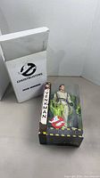 Figure in display box beside white storage box