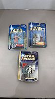 Front view of all three sealed action figures