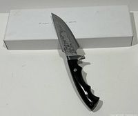 Knife beside closed white box