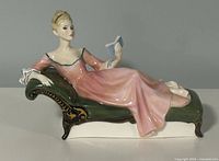 Full view of figurine reclining on chaise
