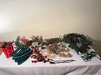 Entire lot laid out showing tree stand parts, garland, floral picks, gold rings, mini light box
