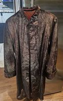 Full view of fur coat on hanger showing length and overall style