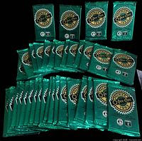 Front view of all 36 sealed green foil packs arranged in rows