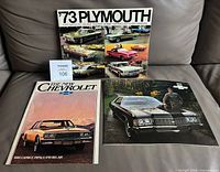 All three brochures laid out on sofa